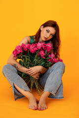 Portrait of a girl with flowers on a bright background