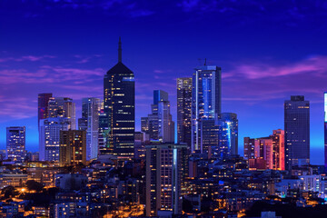 Naklejka premium Urban skylines at night- Witness the dazzling lights and futuristic beauty of urban skylines at night, where towering skyscrapers create a mesmerizing cityscape 