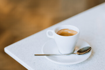 Cup of black coffee on a table in a cafe.