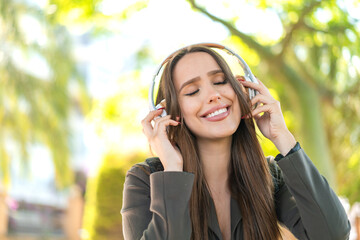 Young woman at outdoors listening music