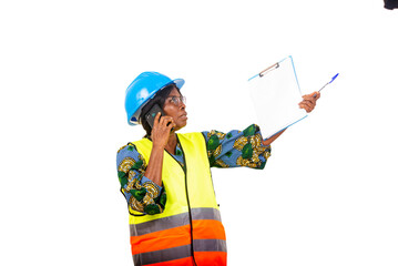 portrait of female engineer in safety helmet talking on mobile phone and pointing up.