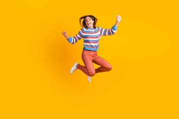 Fototapeta na wymiar Full body size photo of lovely glad cheerful girl jumping having fun rising hands up isolated on bright vivid shine vibrant color background