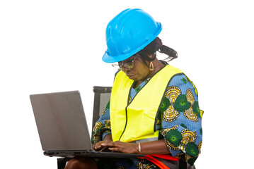 close up of female engineer in protective helmet working using laptop computer.