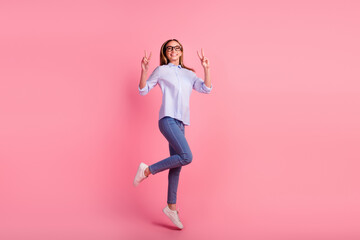 Fototapeta na wymiar Full length body size photo of girl showing two hands v signs jumping high up isolated pink background