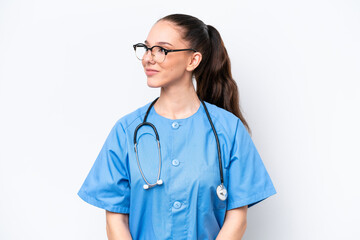 Young caucasian surgeon doctor woman isolated on white background looking side