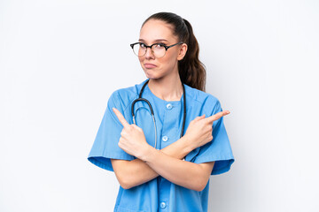 Young caucasian surgeon doctor woman isolated on white background pointing to the laterals having...