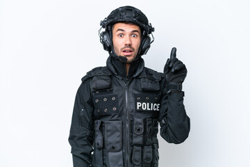 Young caucasian SWAT man isolated on white background thinking an idea pointing the finger up