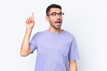 Young caucasian man isolated on white background intending to realizes the solution while lifting a finger up