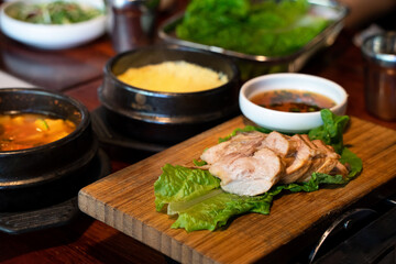 Fresh and delicious iron pan-fried black pork meal in Jeju Korean restaurant.
