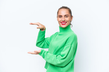Young caucasian woman isolated on white background holding copyspace to insert an ad