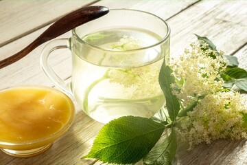 cup of tea from elderberry flowers on a gray background.