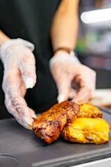 woman chef hand cooking grilled pork neck with baked potatoes and salad