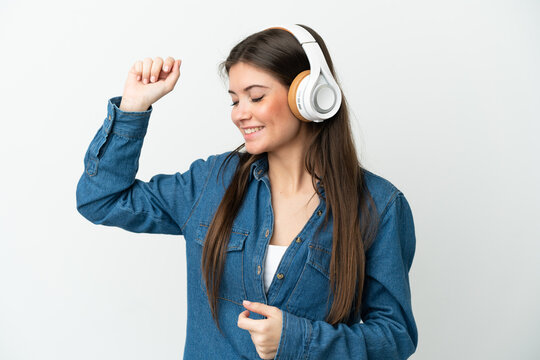 Young Caucasian Woman Isolated On White Background Listening Music And Dancing