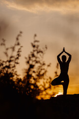 Summer solstice yoga silhouette on sunrise 