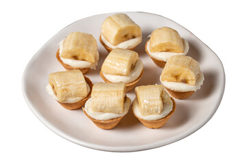Banana tartlet isolated on white background. Delicious tartlet dessert on plate. close up