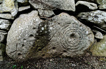 Cup and ring prehistoric carved stone placed into Tealing underground earth house souterrain built by Iron Age farm settlement c2500 years ago