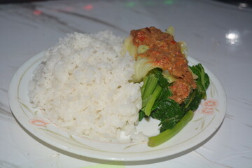 A plate of pecel rice, on a white background.