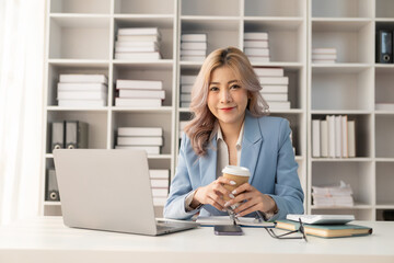 Company employee checking financial data or marketing report working in office with laptop An accountant consults on some documents.