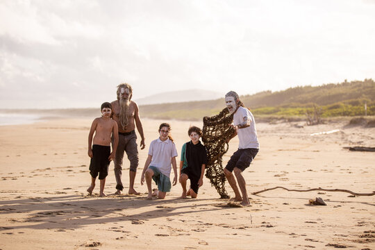 Aboriginal mob at the beach looking at camera focus on foreground