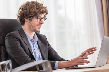 Happy confident businessman video calling on laptop, Business person talking by conference online virtual chat using laptop computer at office