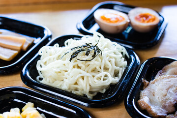 Fresh ramen noodles placed in a black tray