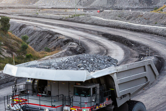 Grey slag in earthmoving machinery in open cut coal mine