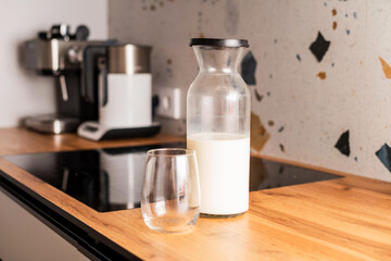 Fototapeta na wymiar A glass jar with milk and a cup