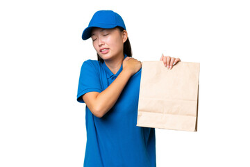 Young Asian woman taking a bag of takeaway food over isolated background suffering from pain in shoulder for having made an effort