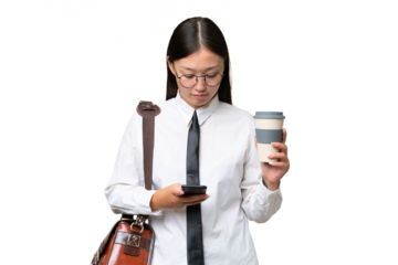 Young Asian business woman over isolated background holding coffee to take away and a mobile