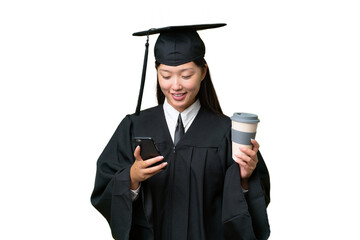 Young university graduate Asian woman over isolated background holding coffee to take away and a mobile