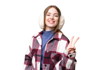 Young pretty woman wearing winter muffs over isolated chroma key background smiling and showing...