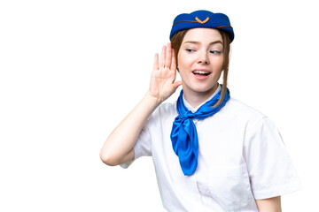 Airplane stewardess over isolated chroma key background listening to something by putting hand on the ear