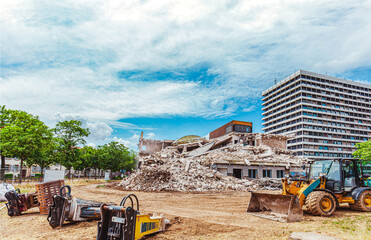 Process of demolition of old building dismantling. Excavator breaking ol house. Destruction of...