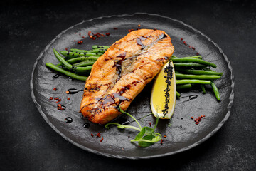 Grilled salmon steak with asparagus and lemon