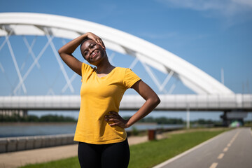 Young woman enjoys exercising outdoor.