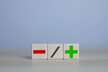wooden blocks with plus and minus signs Comparatively opposite concepts Analyze differences to...