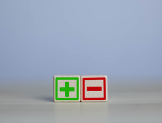 wooden blocks with plus and minus signs Comparatively opposite concepts Analyze differences to...