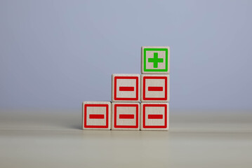 wooden blocks with plus and minus signs Comparatively opposite concepts Analyze differences to...