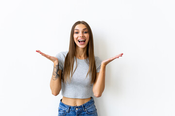 Excited smiling woman with make-up laughing at camera and gesturing with hands isolated over white background