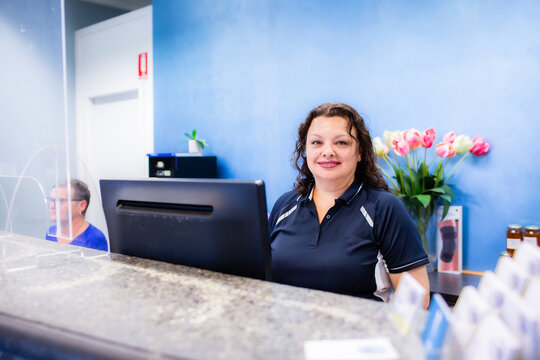 Portrait of female receptionist working at physiotherapist front desk office
