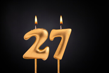 Birthday candle number 27 - Birthday celebration on black background