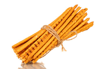 Straw is a bakery product. Several straws tied with jute thread isolated on a white background
