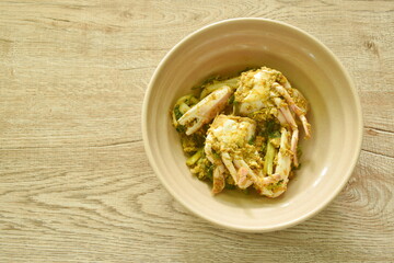 stir fried swimmer crab in yellow curry and egg on bowl