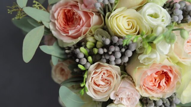 Close up Top view of beautiful modern wedding bouquet, Bouquet of fresh roses for bride. Arrangement of flowers.