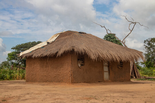 Typical rural mud-house in remote village in Africa with thatched roof, very basic and poor living conditions for local population