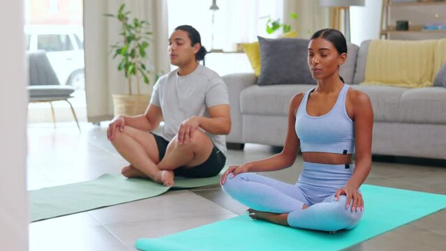 Couple, yoga in living room and breathing, zen with fitness and bonding at home together. Exercise, meditation and interracial people with mindfulness, chakra and healing with workout in apartment