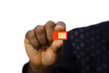 close up of black hand holding red mobile phone sim over white background 