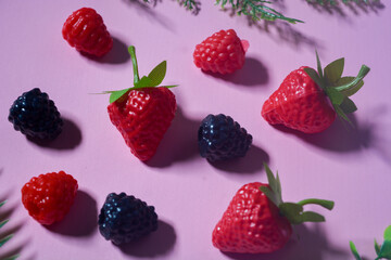 Isolated Blueberry, Blackberry and Strawberry fruit. Against a pink background