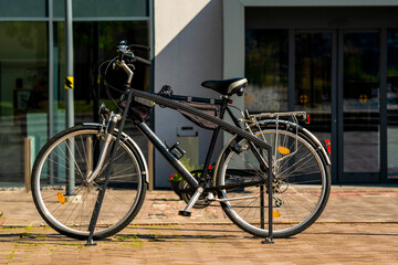 Fototapeta na wymiar Classic black bicycle are parked in the metal bike parking