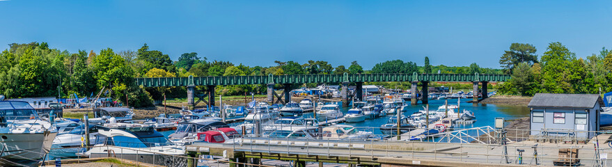 A panorama view towards the railway bridge over the River Hamble, Hampshire in summertime
